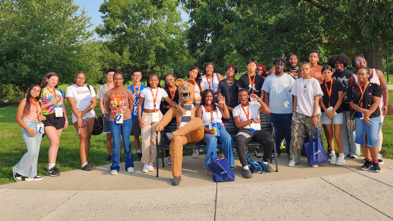 a group of smiling students outside